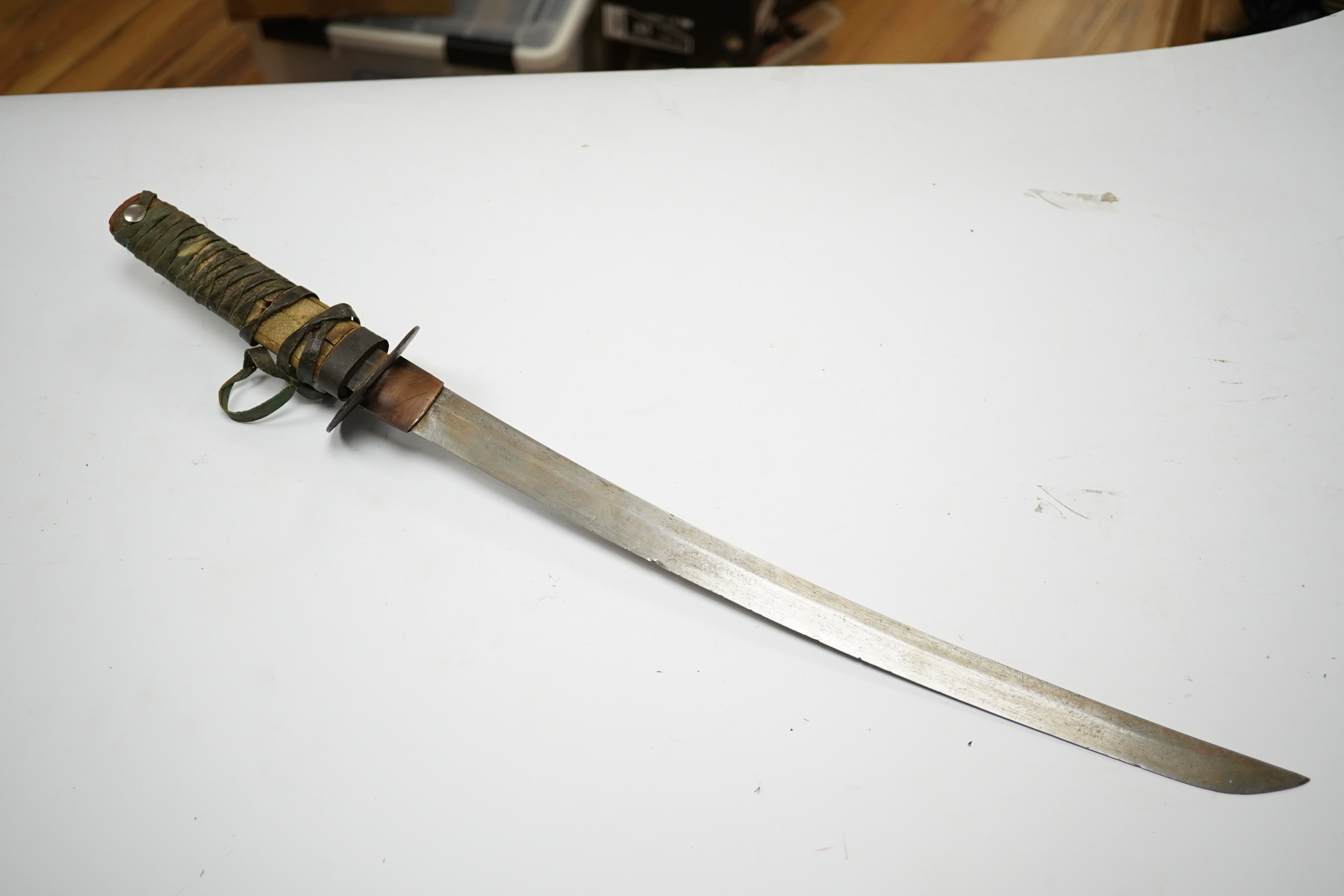 A Japanese sword wakizashi blade 42.8cm signed, iron tsuba, tape bound tsuka, no scabbard. Condition - fair.